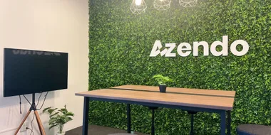 The Azendo logo on a green wall in the Chiang Mai office