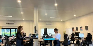 Azendo specialists working at standing desks in the Chiang Mai office