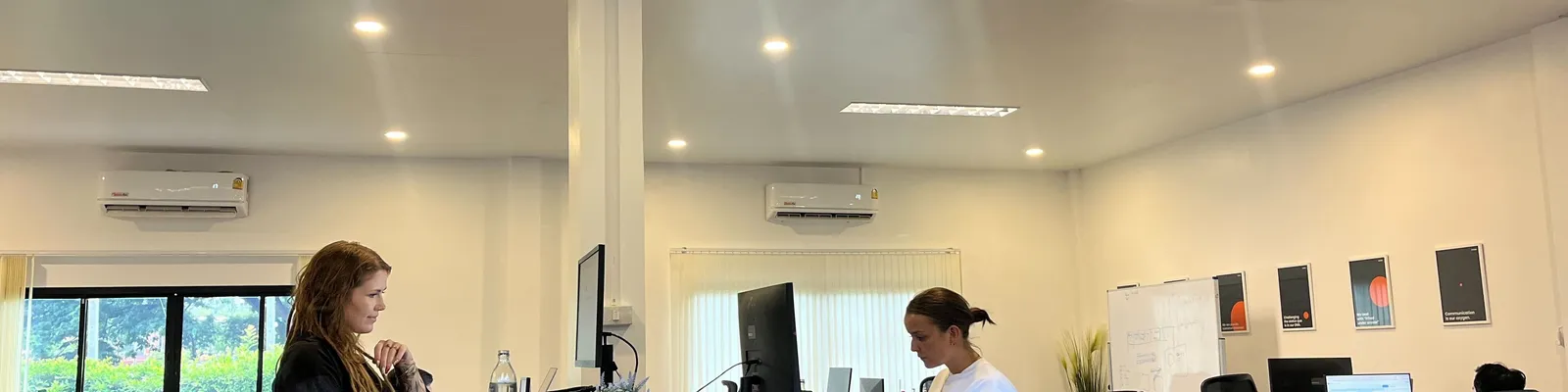 Azendo software engineers working at desks in the Chiang Mai delivery centre