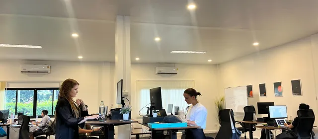 Azendo specialists at standing desks in the Chiang Mai office
