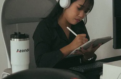 A designer sketching at an Azendo desk