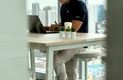 An Azendo software specialist working at a desk in the Bangkok office